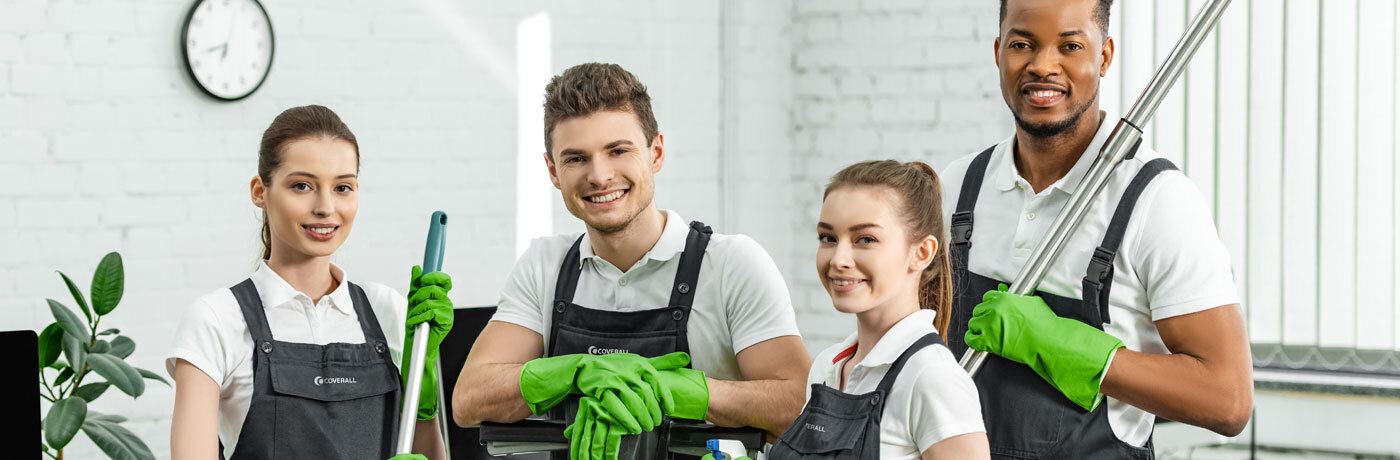 Coverall commercial cleaning team smiling