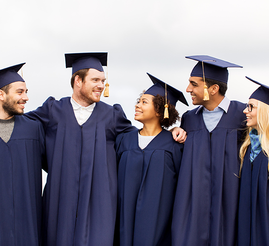 Happy graduates in cap and gowns