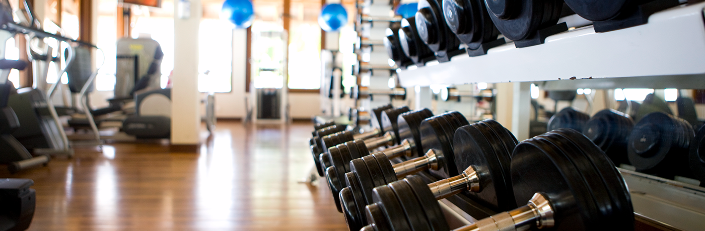 Empty gym with weights in the foreground