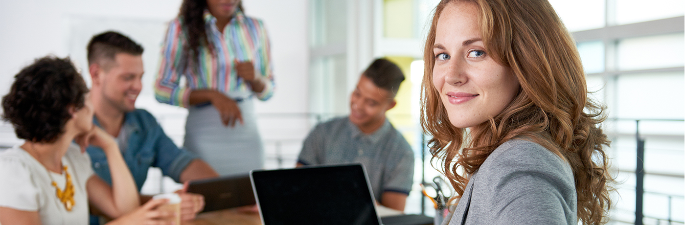 Group of young professionals looking at tablet