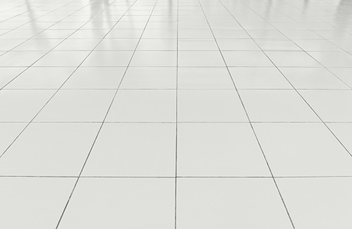 White tiled floor with a grid pattern, creating a clean and bright appearance.
