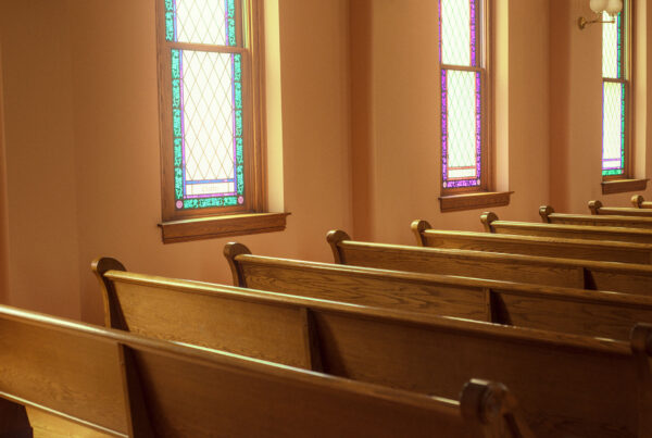 Church pews in front of windows