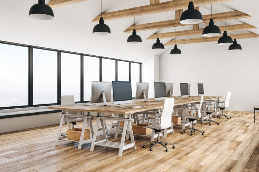 Bright, modern coworking space with desks, chairs and computers