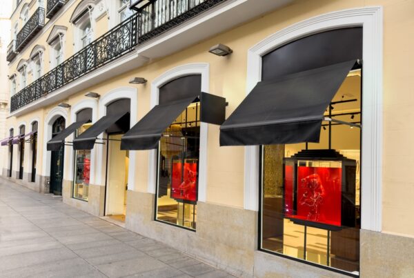 Exterior retail space with large windows and awnings.