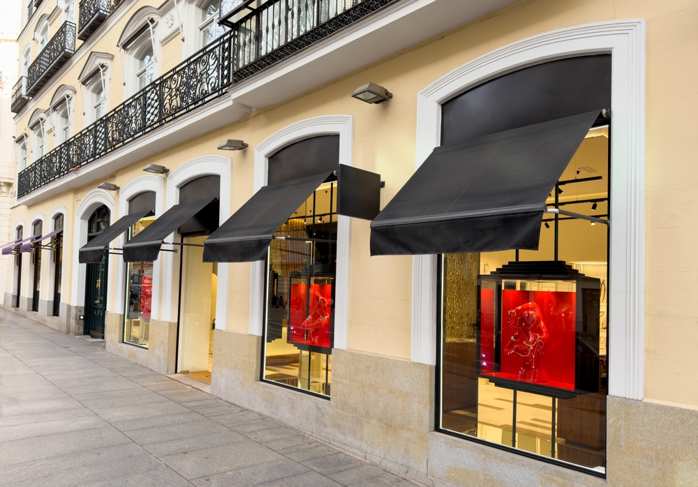 Exterior retail space with large windows and awnings.