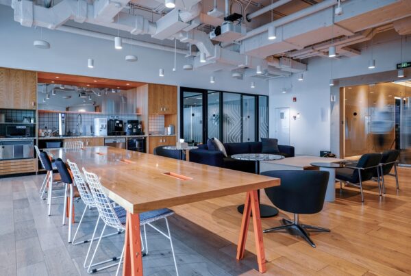 interior office space with common space include desk chairs and kitchen area