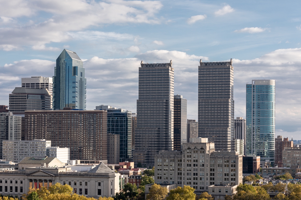 Downtown Philadelphia on a partly sunny sky showcasing the downtown buildings.