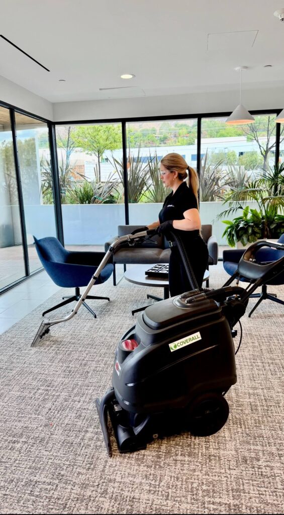 Core4 - Woman in an office with a hot water carpet cleaner