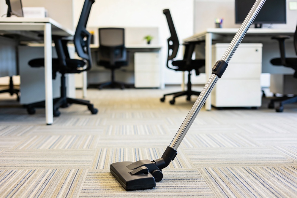 An office environment getting vacuumed.