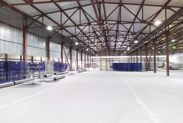 Interior image of a large industrial space with exposed beams.
