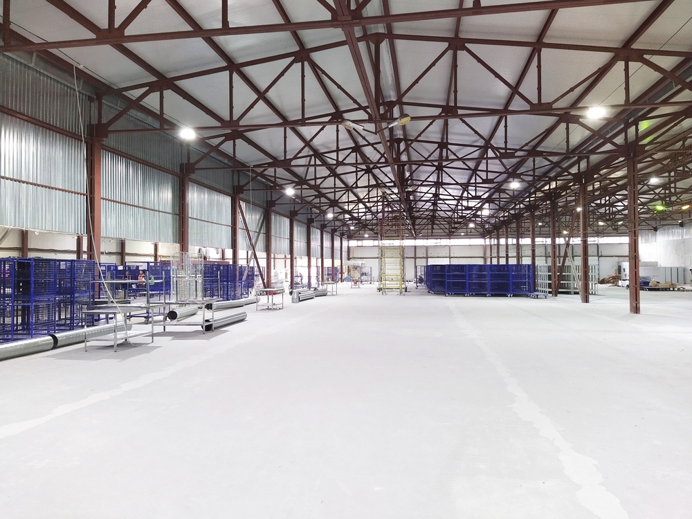 Interior image of a large industrial space with exposed beams.