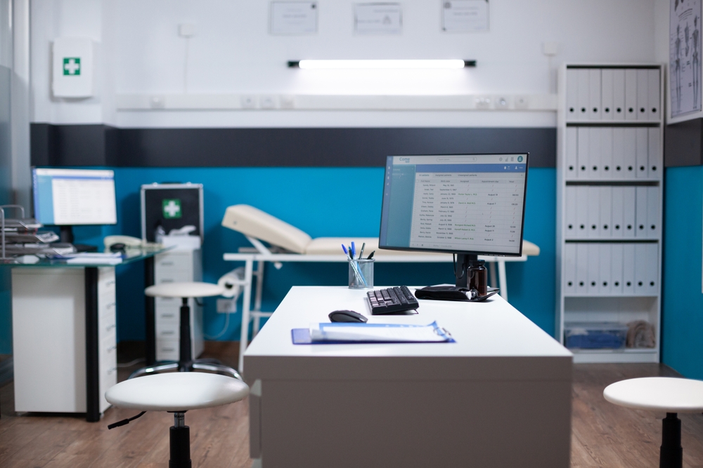 interior medical office that had an exam table, desk chair and equipment.